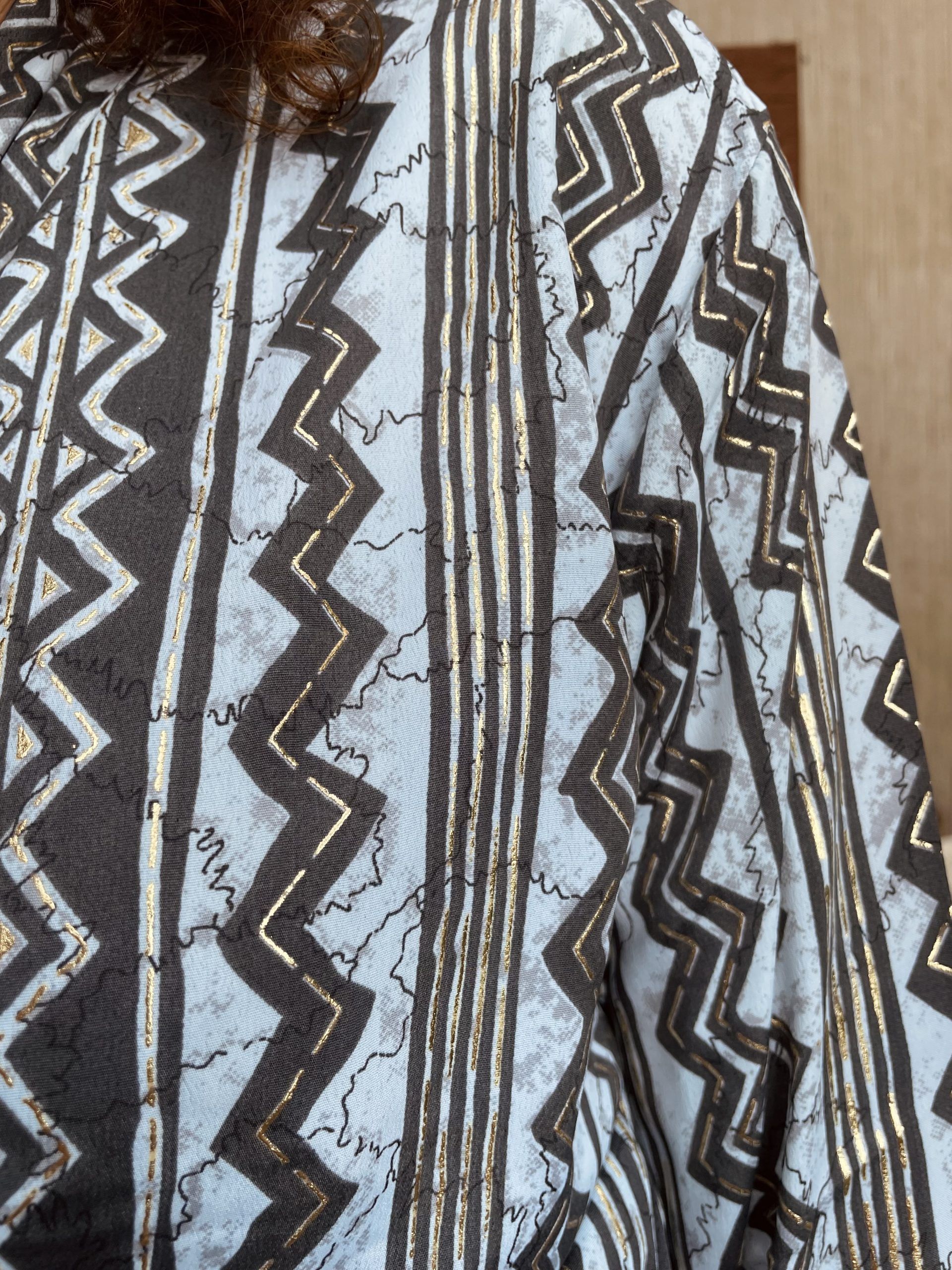 blusa con estampado de grecas en tonos gris plata y celeste